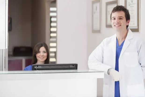 Barman pouring whiskey Doctor and receptionist at clean clinic front desk – representing welcoming environment through doctor office scenting
