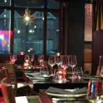 Elegant, ambient restaurant dining area with candlelight – ideal setting for restaurant scenting to enhance guest experience