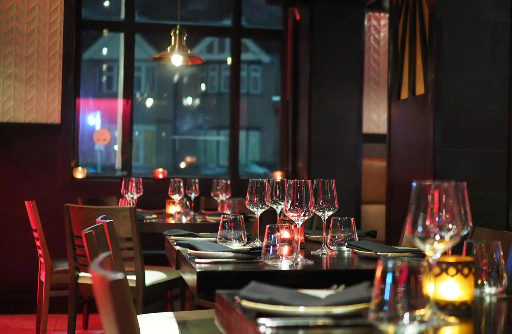 Barman pouring whiskey Elegant, ambient restaurant dining area with candlelight – ideal setting for restaurant scenting to enhance guest experience